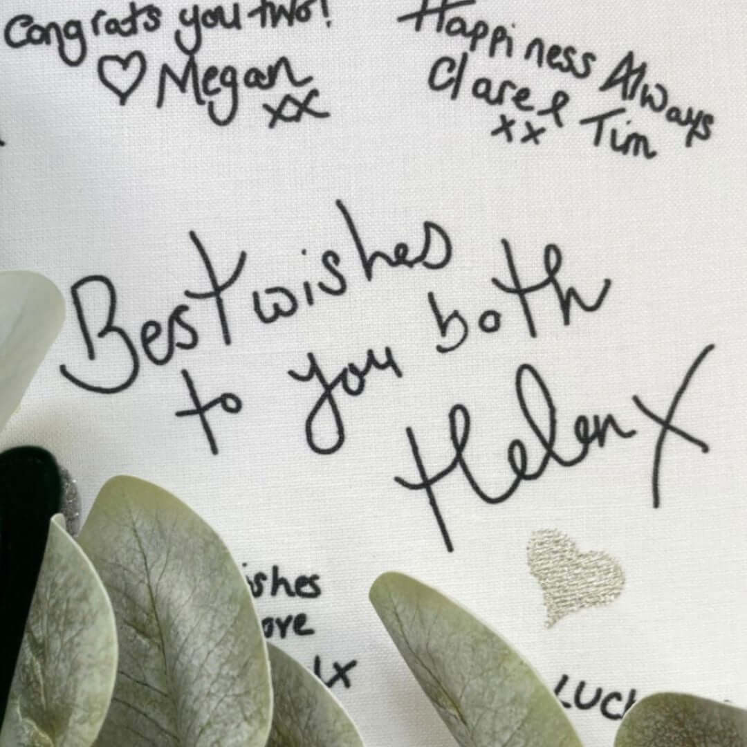 Close up of a printed handwritten message on a Mr & Missive wedding guest book alternative with silver stitched details.